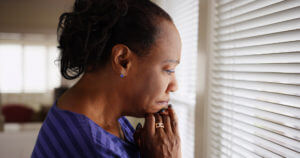 Victim of crime survivor looking out window
